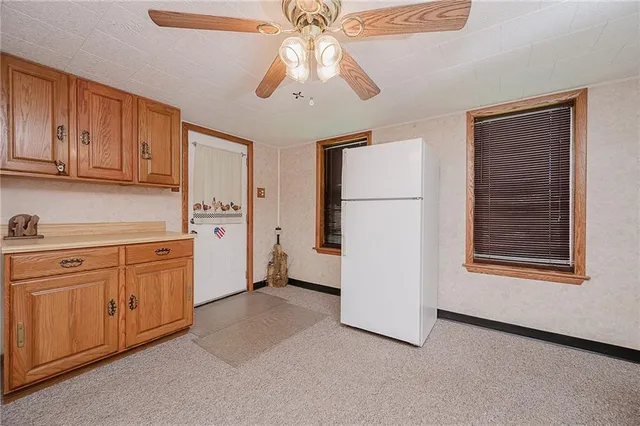 a kitchen with cabinets and window