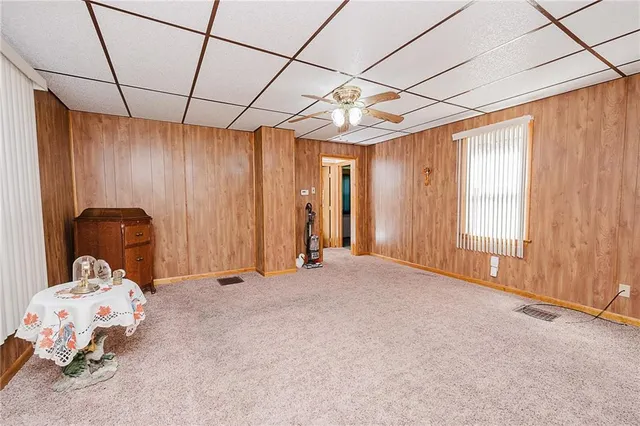 a view of a bedroom with a bed and a window