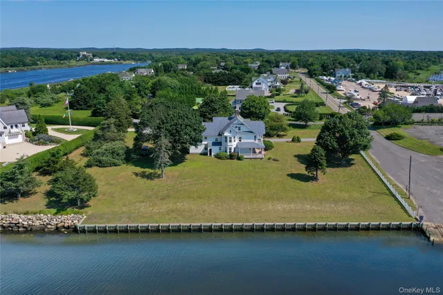 an aerial view of a house with a garden and lake view