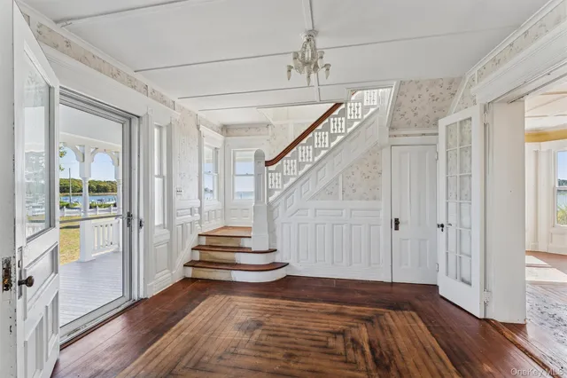 a view of entryway and hall with wooden floor