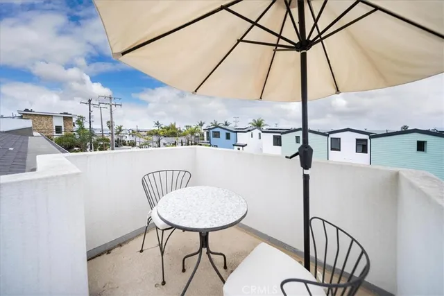 a view of a chairs and table in the balcony