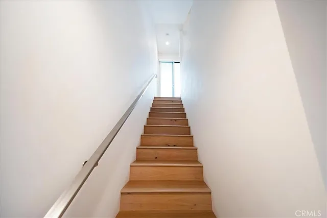 a large bed sitting in a bedroom next to a window