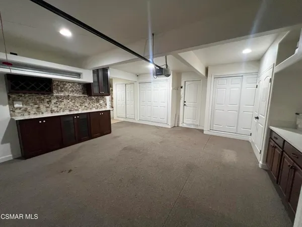 a view of an empty room with a staircase and a shower