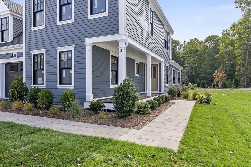 46 Sandwich Road, Unit 26 Plymouth, MA 02360 - Photo 5 of 41 a front view of a house with yard and green space