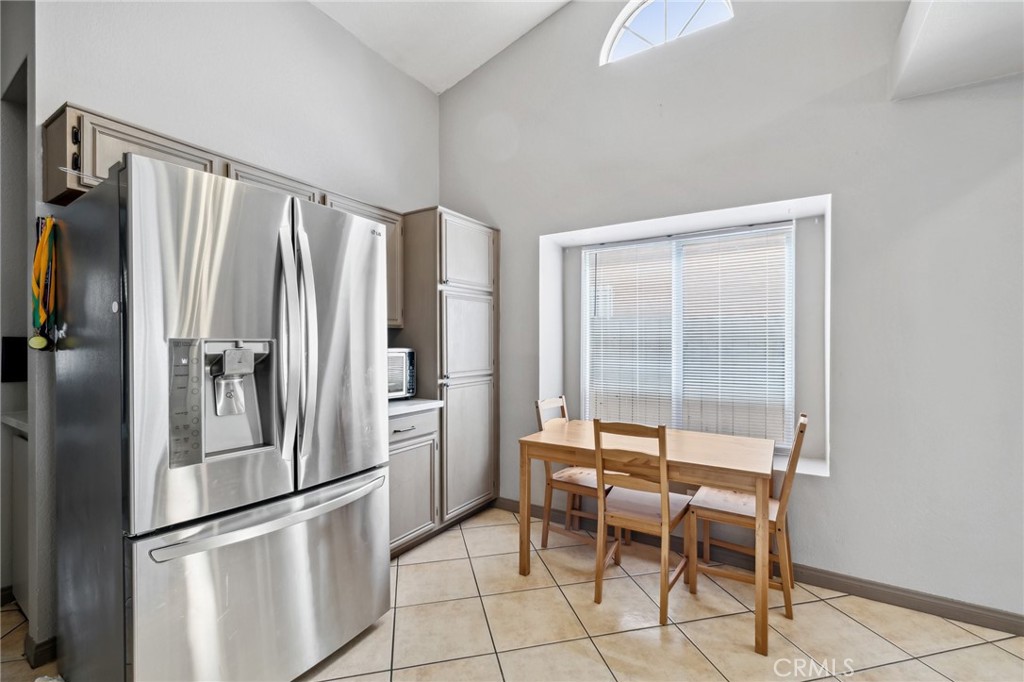 129 Avocado Avenue Perris, CA 92571 - Photo 11 of 30 a kitchen with stainless steel appliances a refrigerator and a stove top oven