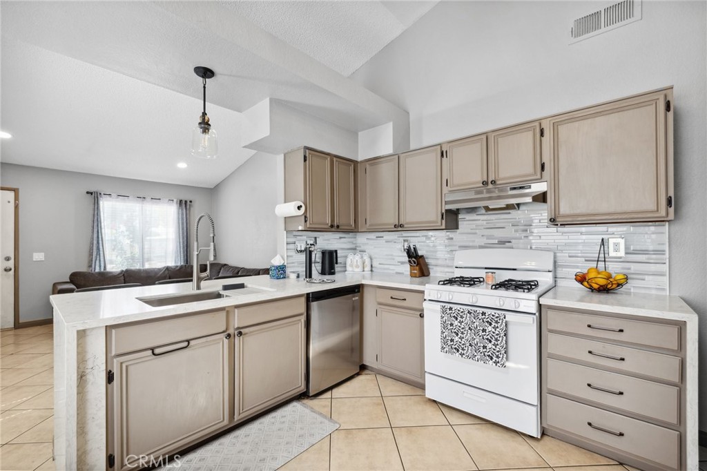 129 Avocado Avenue Perris, CA 92571 - Photo 13 of 30 a kitchen with a sink window and cabinets