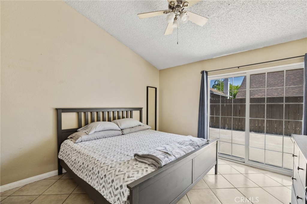 129 Avocado Avenue Perris, CA 92571 - Photo 14 of 30 a bedroom with a large bed and a chandelier
