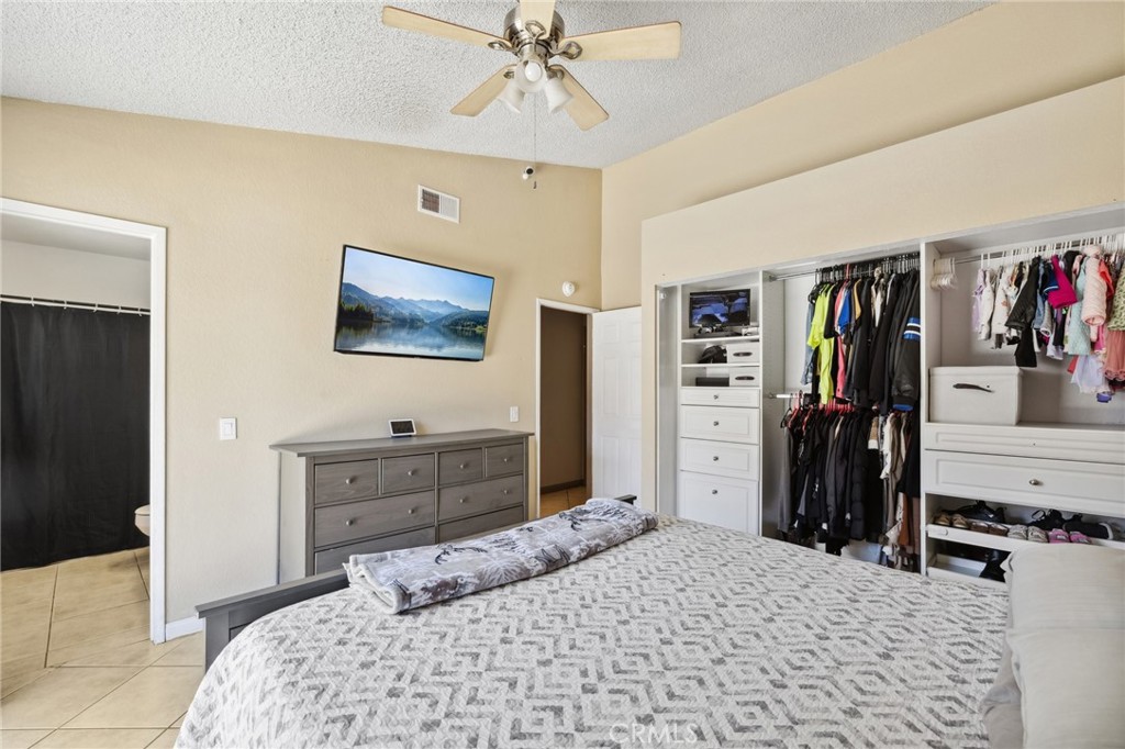 129 Avocado Avenue Perris, CA 92571 - Photo 15 of 30 a bedroom with a bed and a chandelier