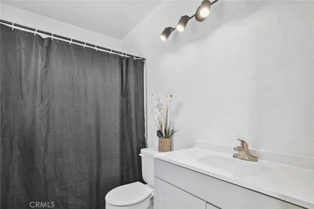 129 Avocado Avenue Perris, CA 92571 - Photo 16 of 30 a bathroom with a sink toilet and shower
