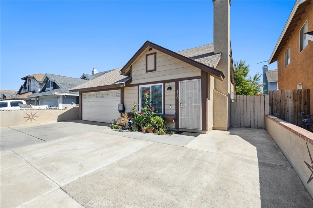 129 Avocado Avenue Perris, CA 92571 - Photo 6 of 30 a front view of a house with a yard and garage