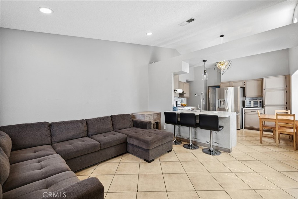 129 Avocado Avenue Perris, CA 92571 - Photo 7 of 30 a living room with furniture and a view of kitchen