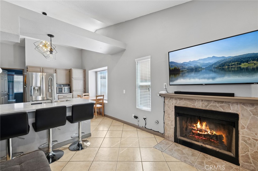 129 Avocado Avenue Perris, CA 92571 - Photo 8 of 30 a living room with furniture a fireplace and kitchen view