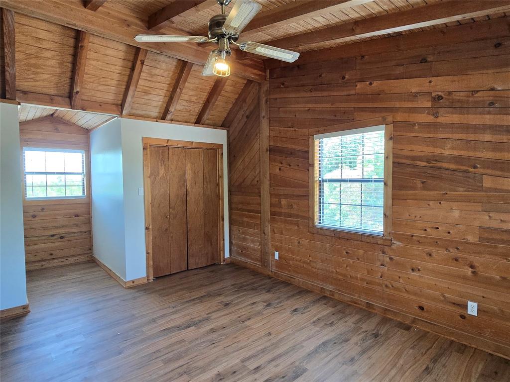 3505 Farmer Road Azle, TX 76020 - Photo 28 of 40 Wood ceilings and beams give this room a rustic flair.