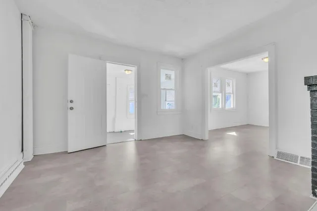 an empty room with windows and closet