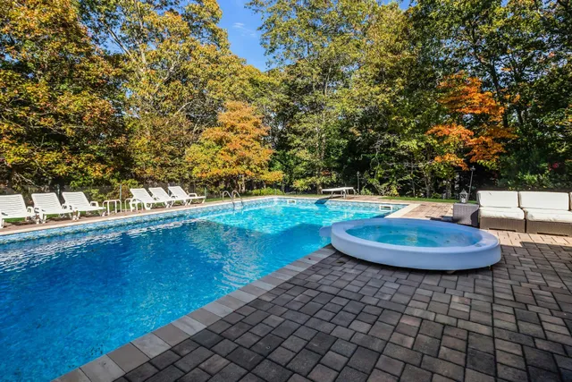 a view of a swimming pool with a yard