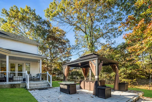 a view of a chair and table in the garden
