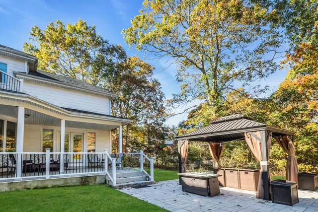 a view of a chair and table in backyard of the house