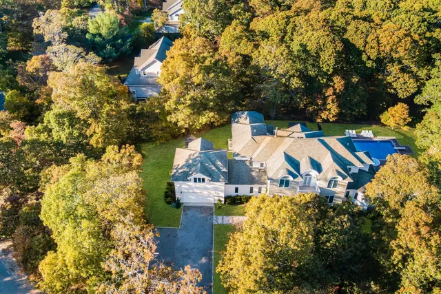 a view of a house with a yard and pool