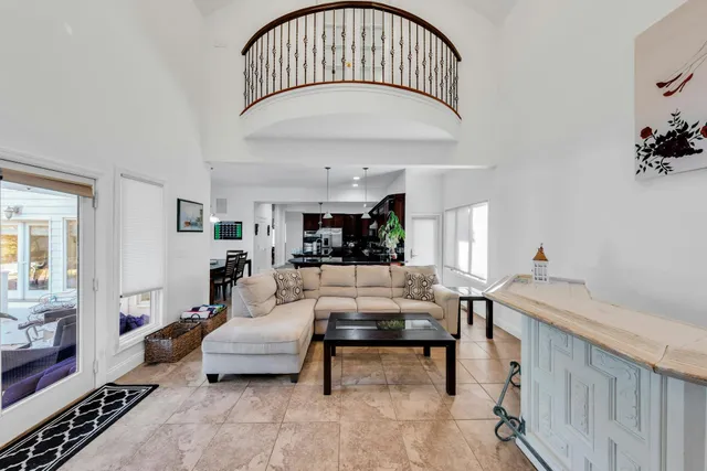 a living room with furniture and a chandelier