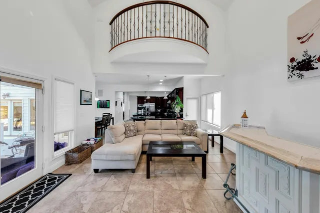 a living room with furniture and a chandelier
