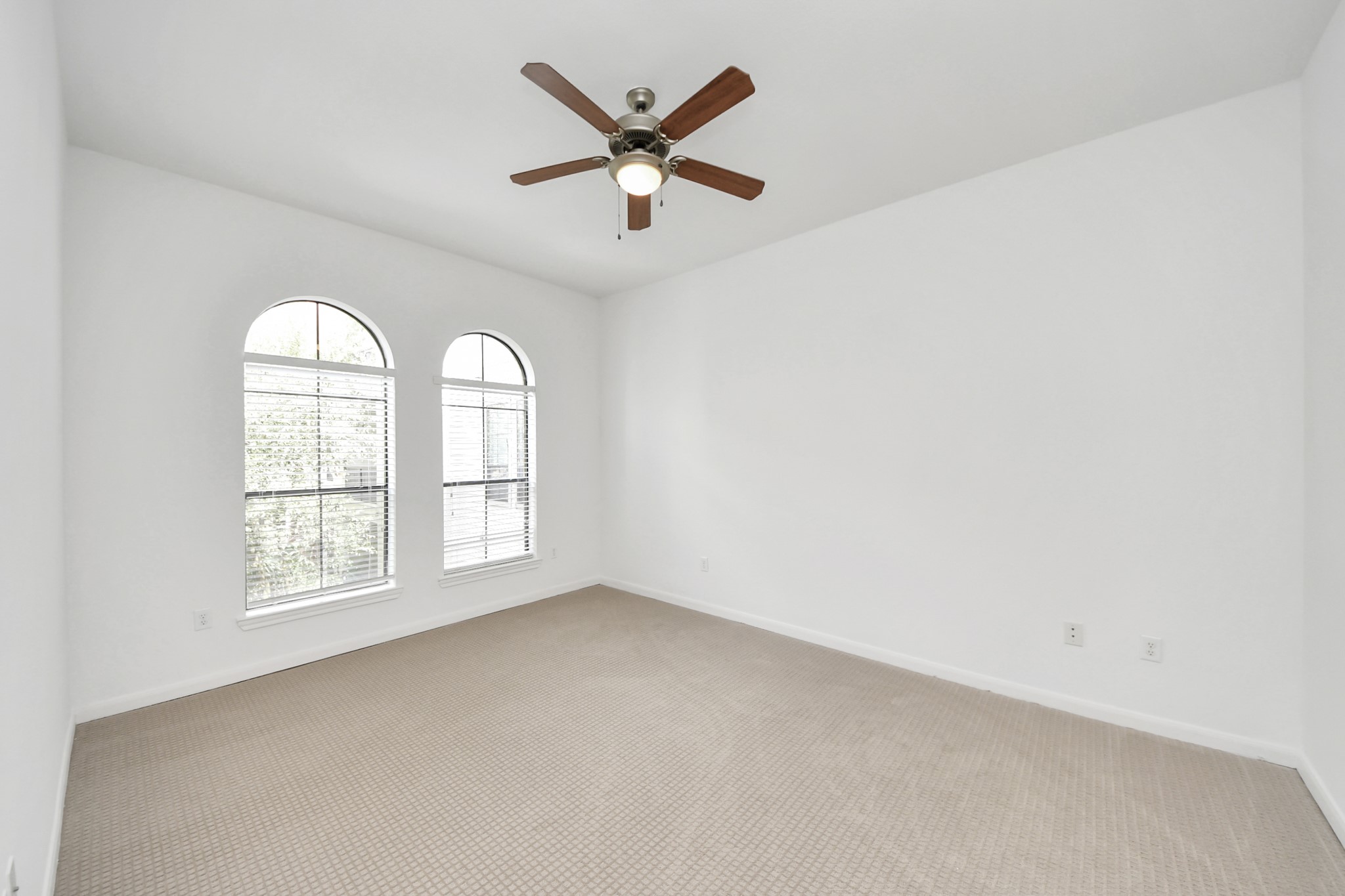 6363 San Felipe Street, Unit 465 Houston, TX 77057 - Photo 15 of 49 an empty room with windows and ceiling fan