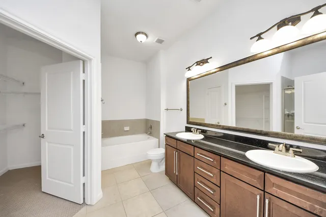 a bathroom with a sink a mirror and a bathtub