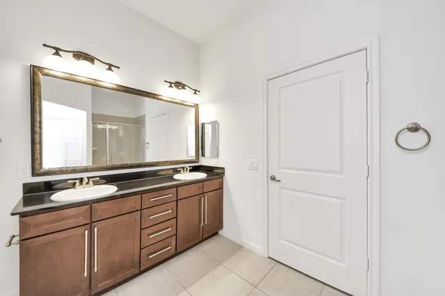 a bathroom with a double vanity sink and mirror