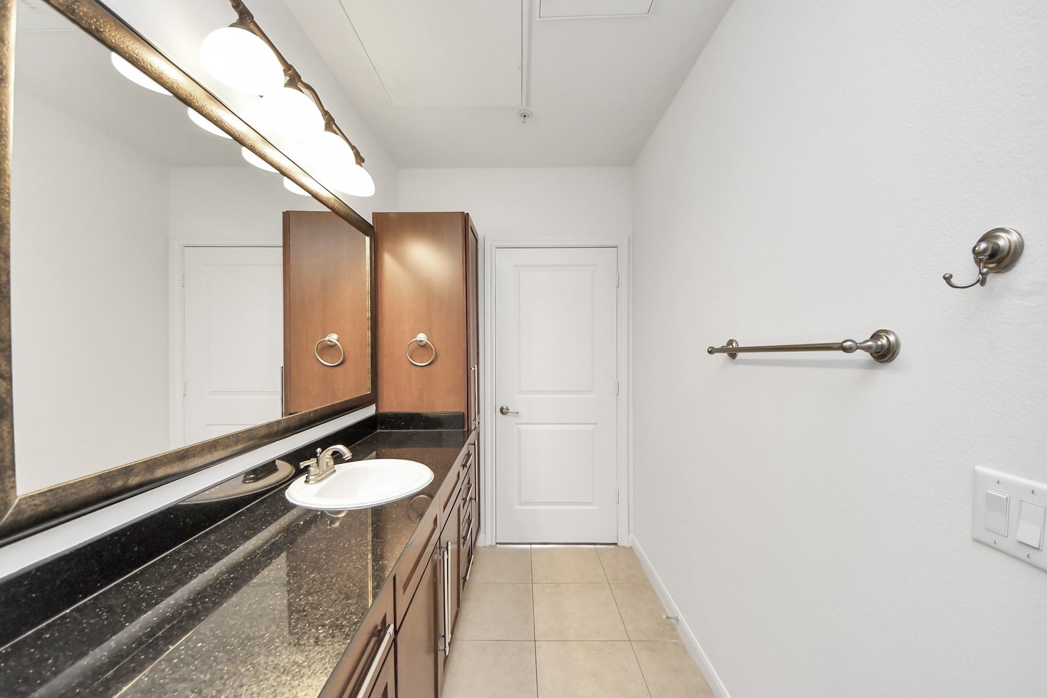6363 San Felipe Street, Unit 465 Houston, TX 77057 - Photo 29 of 49 a bathroom with a sink a light fixture and a mirror
