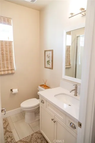 a bathroom with a sink toilet and vanity