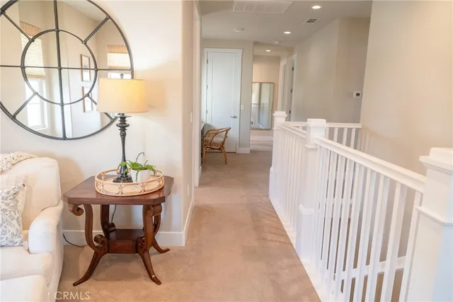 a dining room with furniture and a mirror