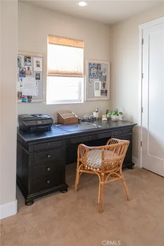 a dining room with a desk and a window