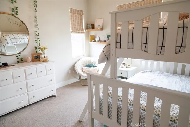 a living room with furniture and a mirror