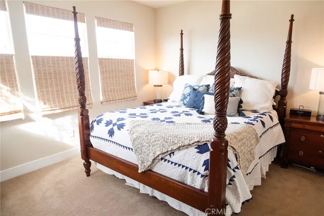 a bedroom with a bed and large window