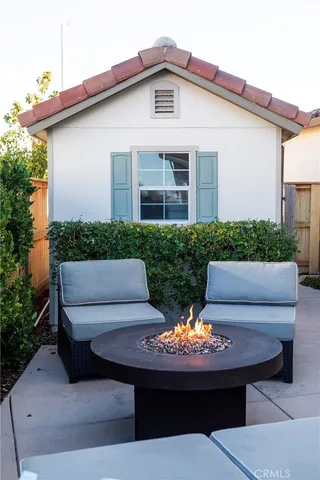 a view of a patio with couches table and chairs and potted plants