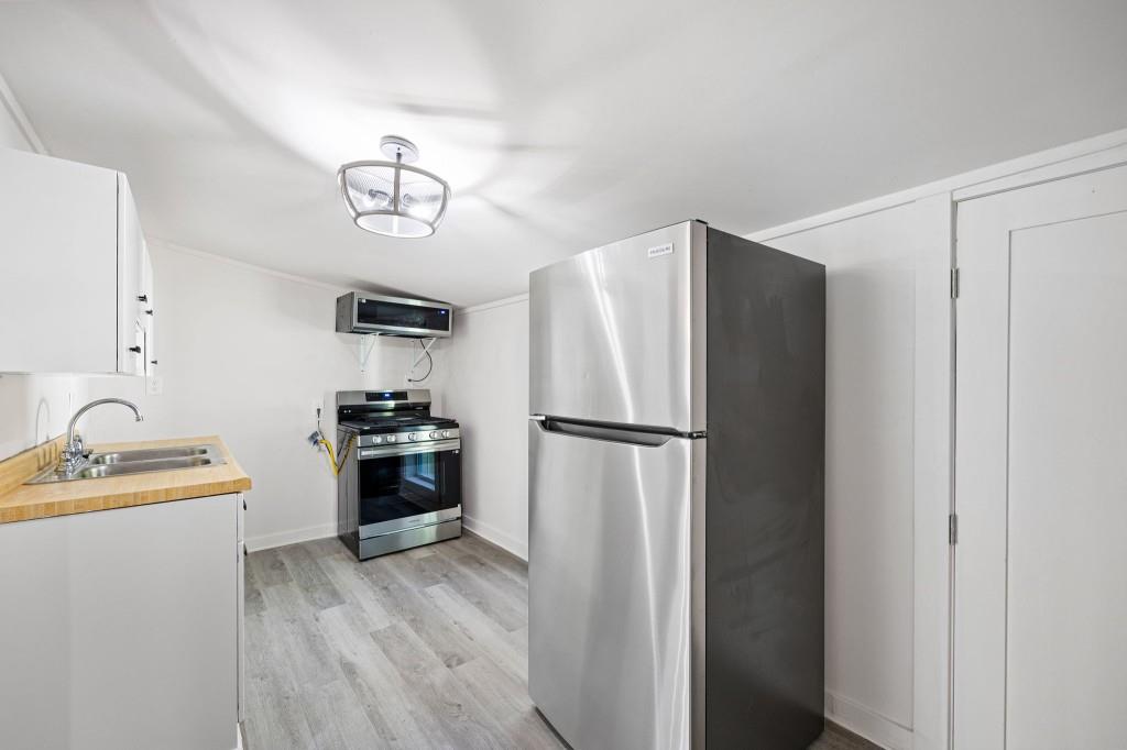 24 East Iron Belt Road Southeast Cartersville, GA 30120 - Photo 15 of 39 a kitchen with a refrigerator and a sink