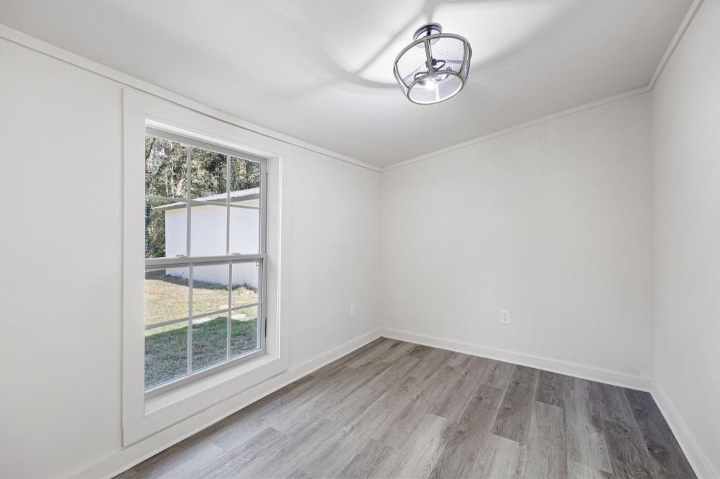 24 East Iron Belt Road Southeast Cartersville, GA 30120 - Photo 20 of 39 an empty room with wooden floor and windows