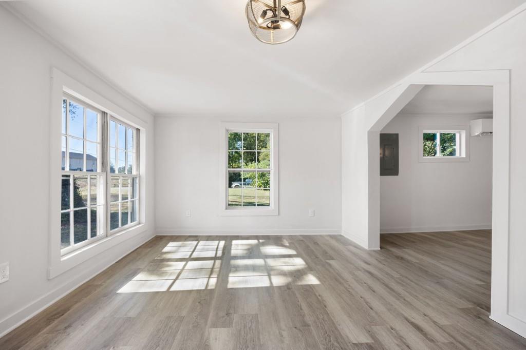 24 East Iron Belt Road Southeast Cartersville, GA 30120 - Photo 7 of 39 a view of an empty room with wooden floor and a window