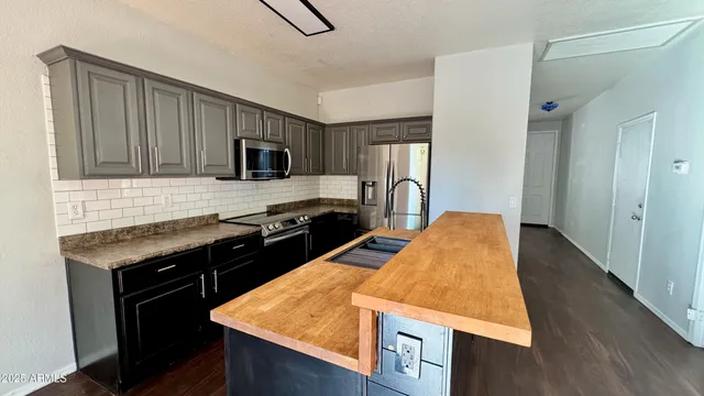 a kitchen with a stove a sink and a refrigerator