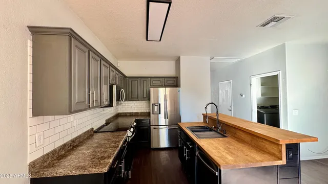 a living room with stainless steel appliances kitchen island granite countertop furniture and a kitchen view