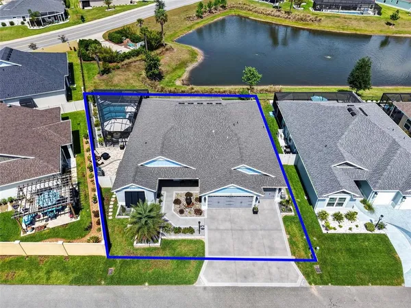 an aerial view of a house with a yard