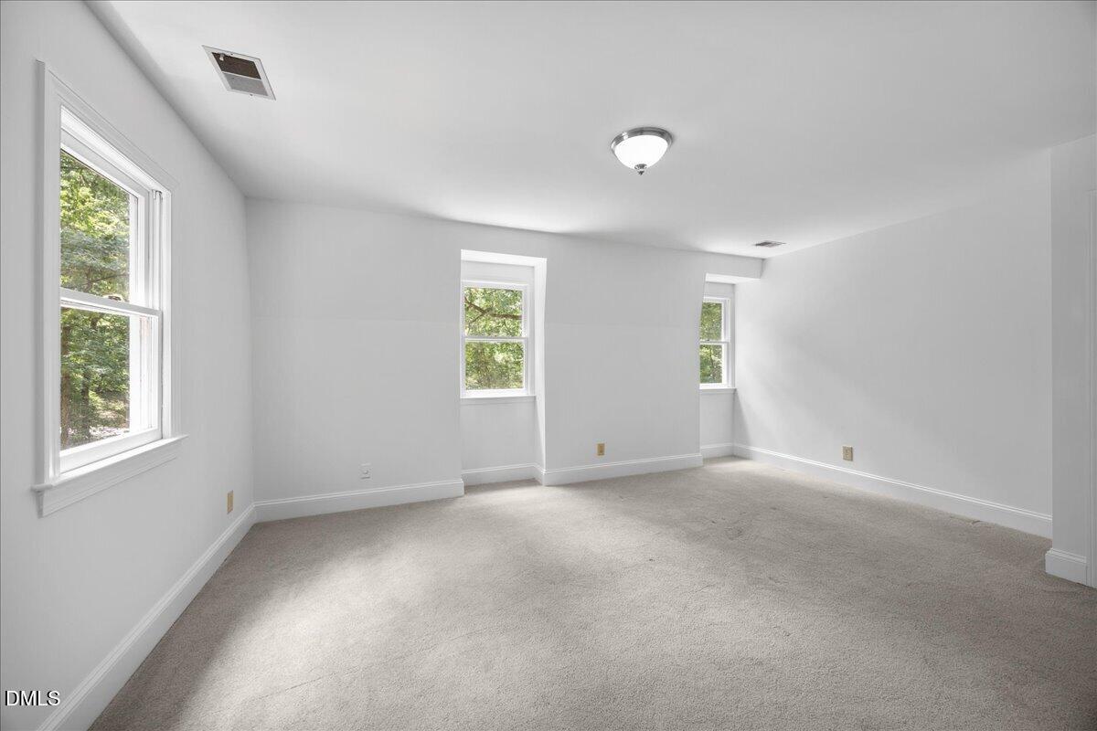 6516 Bakersfield Drive Raleigh, NC 27606 - Photo 42 of 59 an empty room with windows