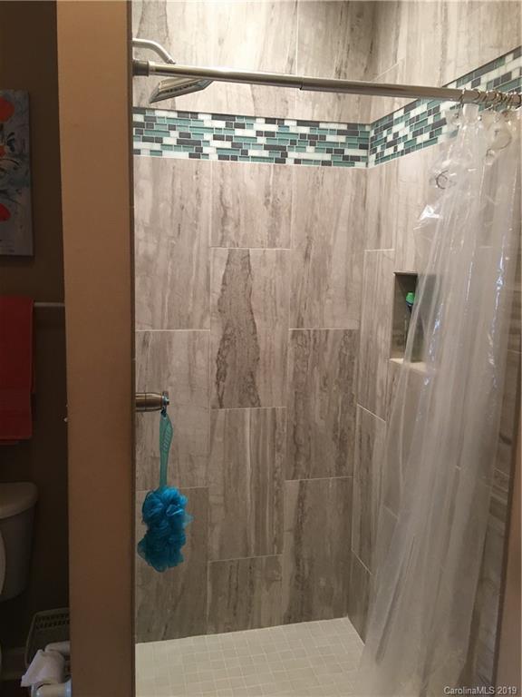 779 Peninsula Drive Davidson, NC 28036 - Photo 12 of 31 a bathroom with a shower curtain and sink