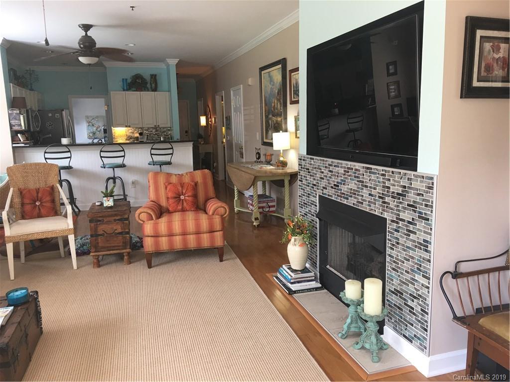 779 Peninsula Drive Davidson, NC 28036 - Photo 16 of 31 a living room with furniture a flat screen tv and a fireplace