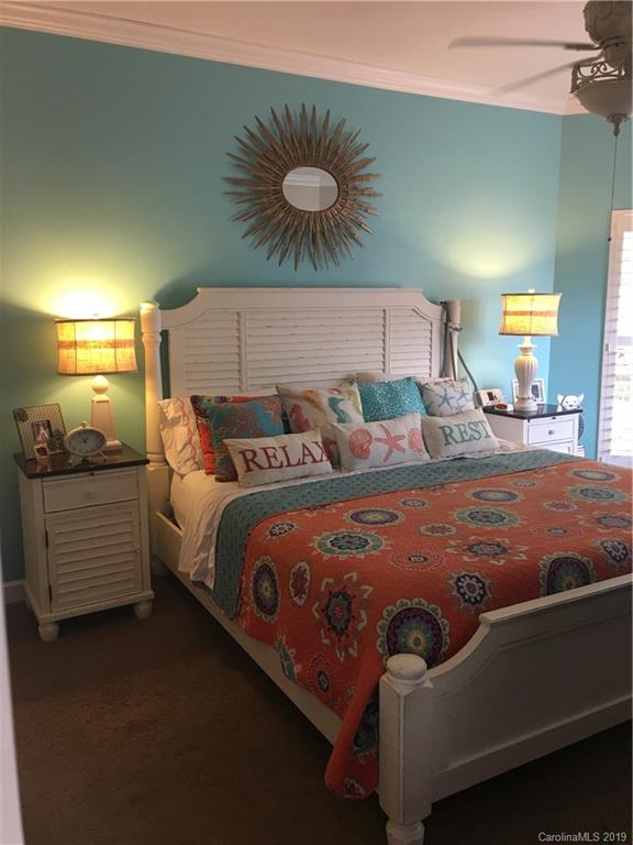 779 Peninsula Drive Davidson, NC 28036 - Photo 19 of 31 a bedroom with a bed and chandelier