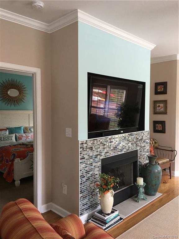 779 Peninsula Drive Davidson, NC 28036 - Photo 3 of 31 a living room with furniture a flat screen tv and a fireplace