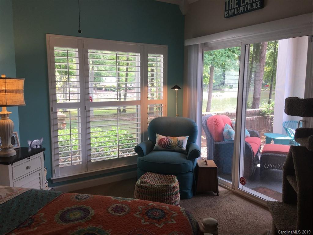 779 Peninsula Drive Davidson, NC 28036 - Photo 21 of 31 a living room with furniture and a floor to ceiling window