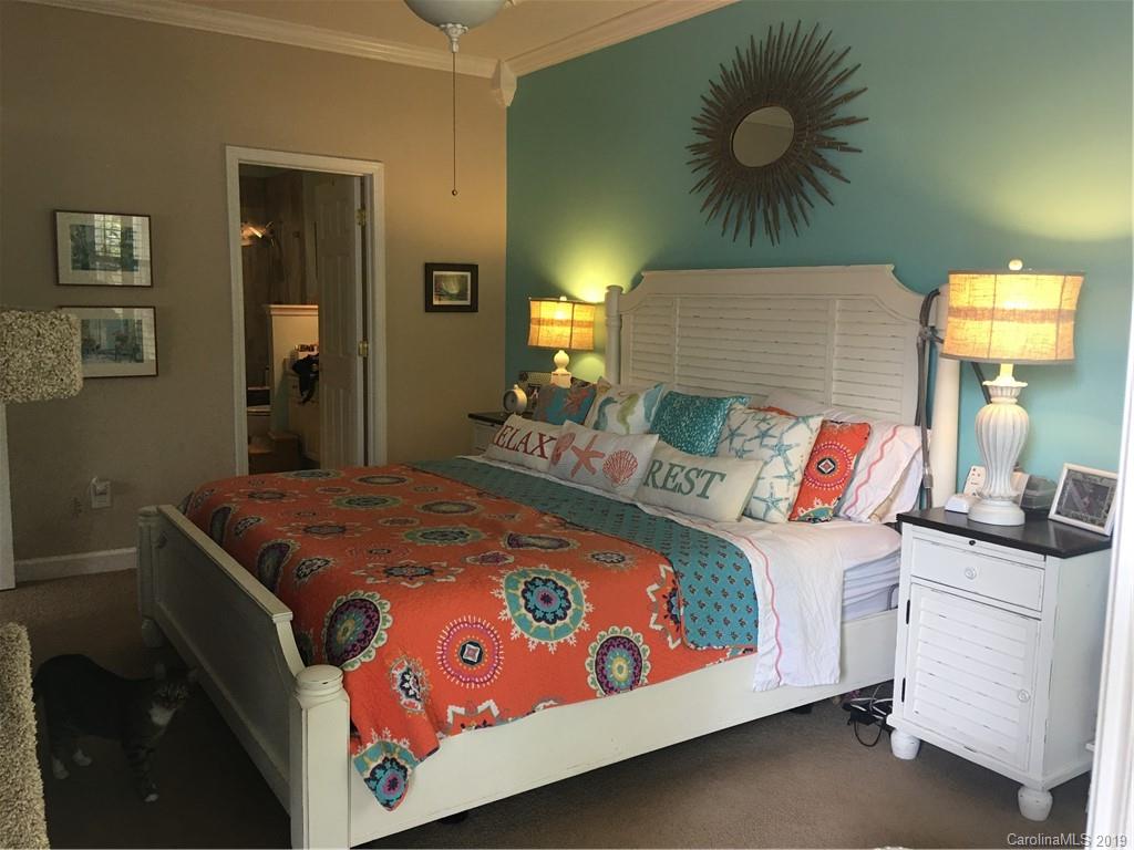 779 Peninsula Drive Davidson, NC 28036 - Photo 22 of 31 a bedroom with a bed and a painting on the wall