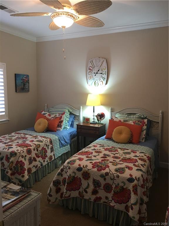 779 Peninsula Drive Davidson, NC 28036 - Photo 8 of 31 a bedroom with two beds and a chandelier