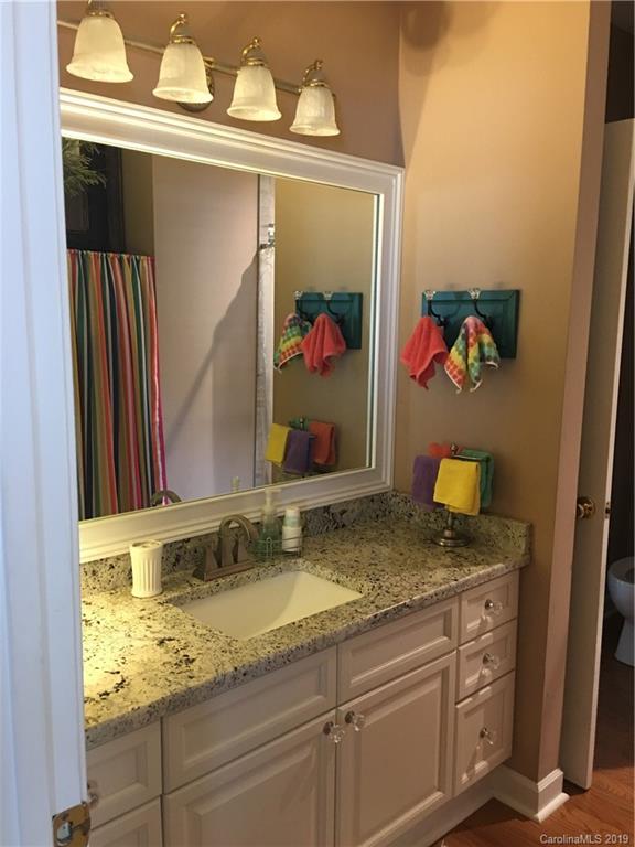 779 Peninsula Drive Davidson, NC 28036 - Photo 10 of 31 a bathroom with a granite countertop sink and a mirror