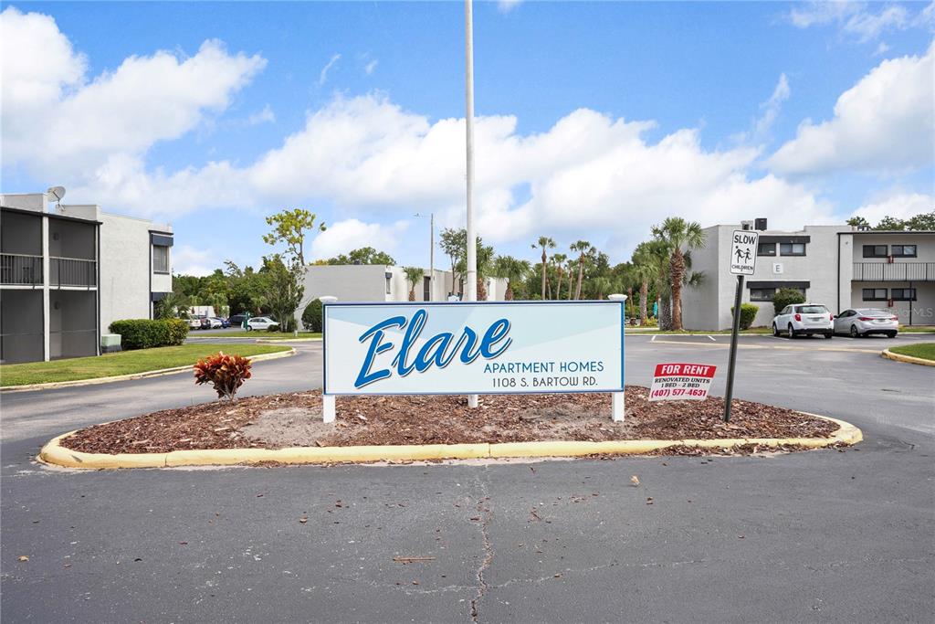 1108 Bartow Road, Unit 100 Lakeland, FL 33801 - Photo 1 of 15 a street view with building and car parked in the background